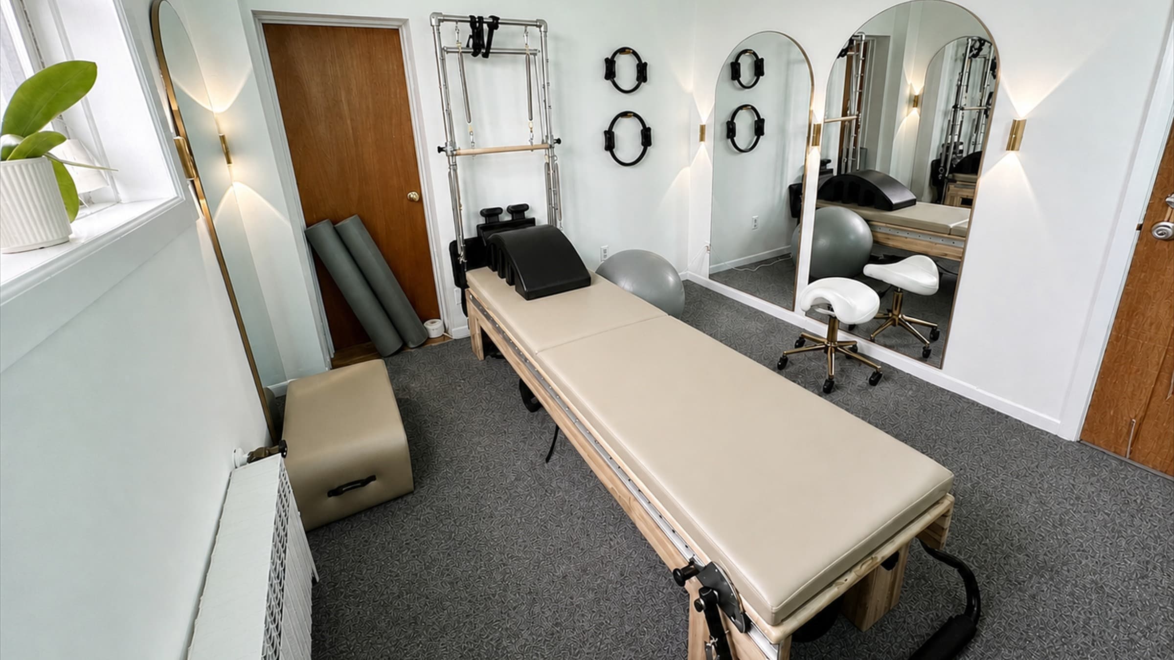 The reformer, tower equipment, and mirrors inside Atelier Pilates